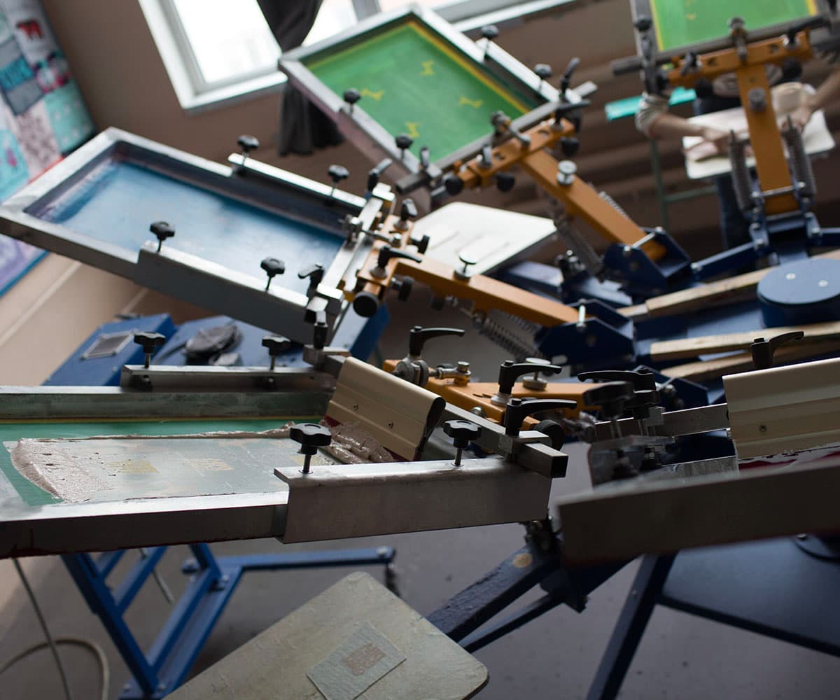 Automatic screen printing press at ThreadCo Print Shop