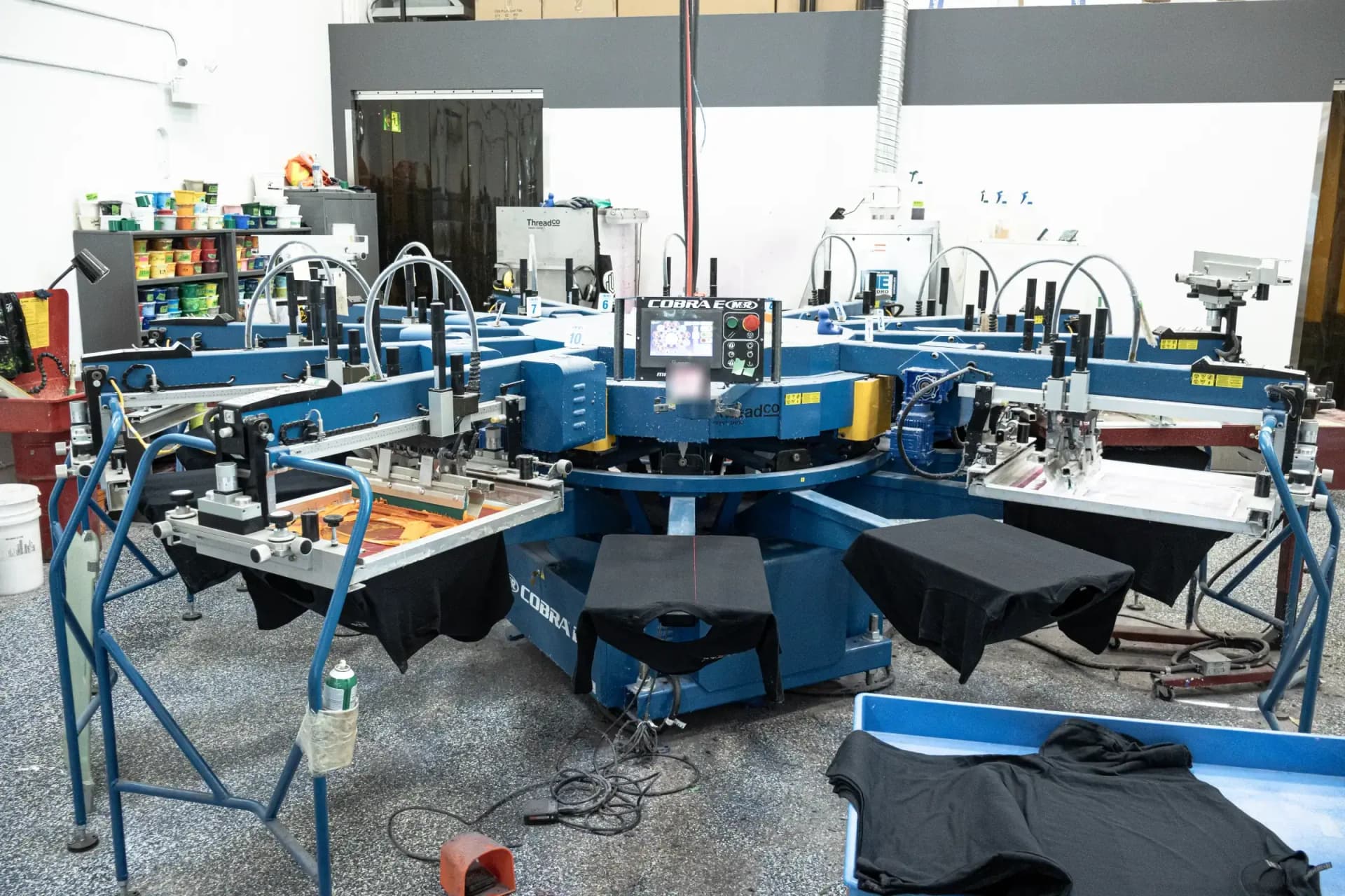 The M&R Cobra automatic screen-printing press on the ThreadCo Print Shop floor in Vancouver