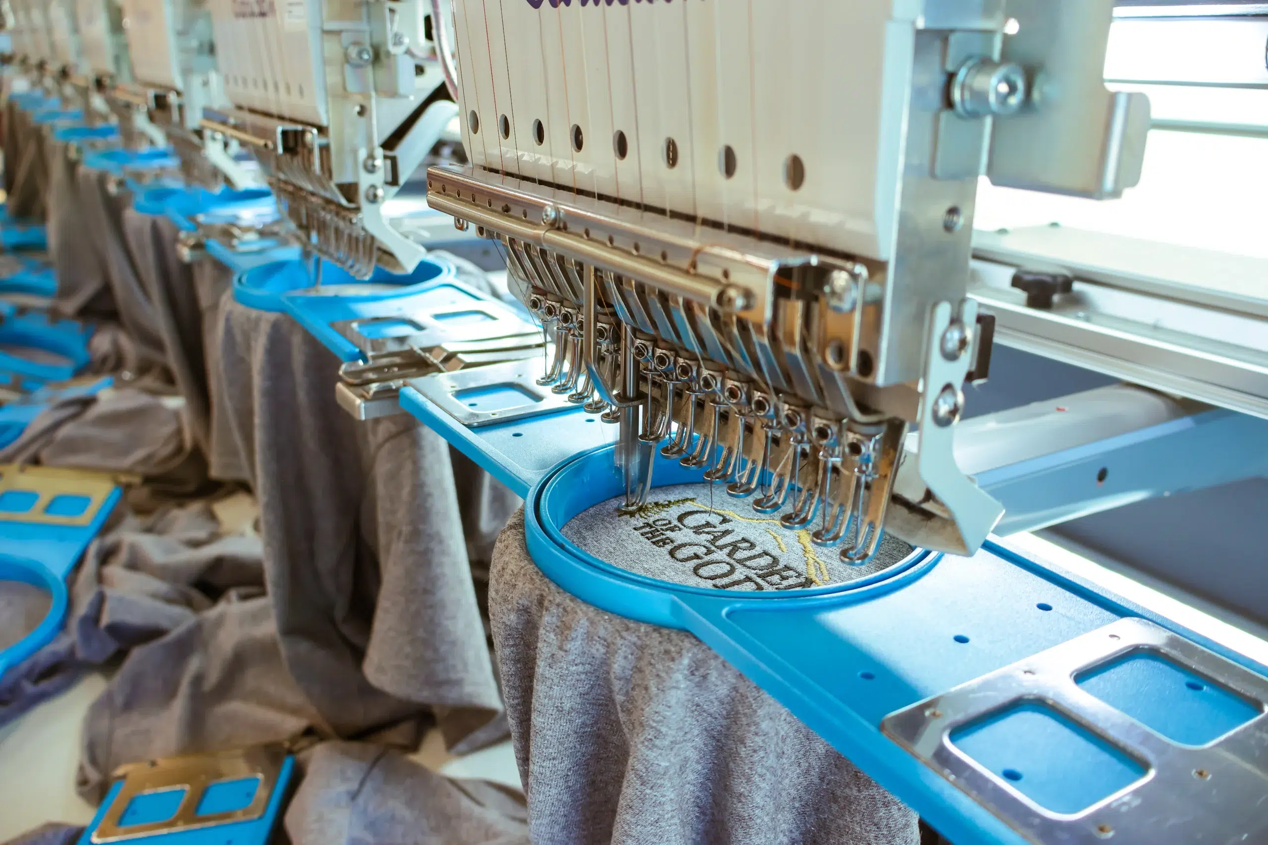 Custom embroidery machines working on apparel